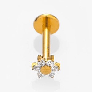 Detail of golden flower labret stud with zircon petals and flat back piercing jewelry