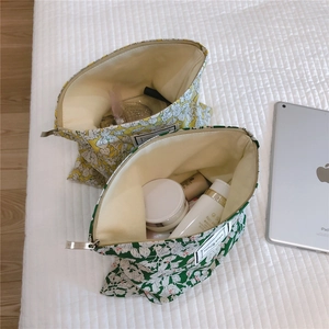 Detailed internal view of floral cotton makeup bags with green and yellow leaf patterns