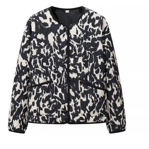 Women's short quilted jacket featuring black and white animal print with diamond pattern