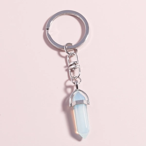 Close-up of hexagonal blue crystal pendant with silver metal ring and rotating clasp
