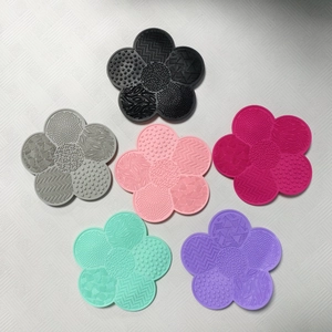 Silicone cosmetic brush cleaning mats in six colors featuring various textured patterns
