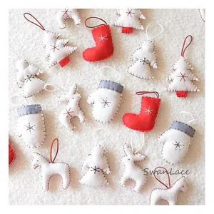 Detailed view of handmade felt Christmas ornaments with star embroidery and hanging ropes