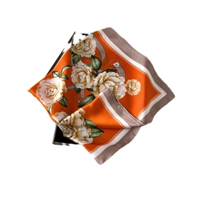 Elegant orange floral satin scarf featuring large white flowers and green leaves pattern