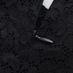 Macro detail of high-quality invisible zipper on black lace dress with fine sewing finish