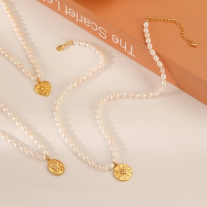 Elegant baroque freshwater pearl necklaces with gold heart and sunburst pendants