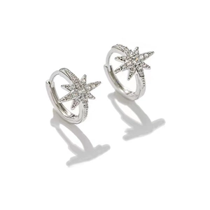 Close-up of silver starburst ear cuffs with micro-paved white cubic zirconia stones