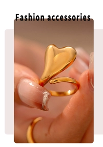 Detailed macro view of 18k gold plated heart wrap ring with glossy polished finish