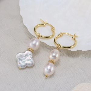 Detailed macro view of S925 silver asymmetric earrings with Baroque freshwater pearls