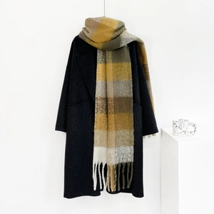 Detail of colorful plaid scarf with thick mohair texture and long fringe tassels