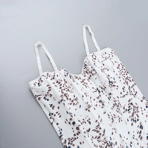 Detailed view of white floral corset top featuring internal boning and abstract patterns