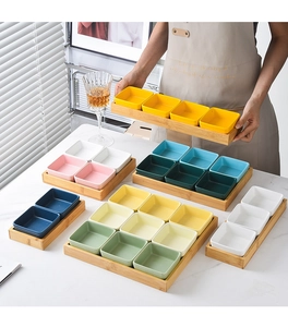 Set of colorful ceramic snack bowls with bamboo trays in multiple size variations
