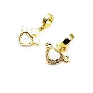 Detailed view of gold winged heart charms with micro-pave cubic zirconia accents