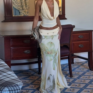 Detail of high-slit floral maxi skirt and halter neck top set in light yellow