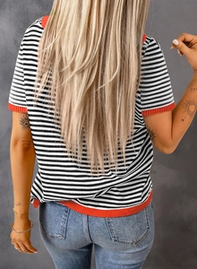 Detail view showing black and white striped knit texture with red contrast ribbed hem on back