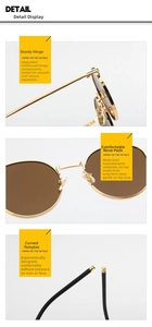 Close-up of vintage round metal sunglasses with reinforced hinges and anti-allergy nose pads