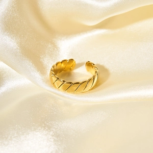 Adjustable golden twisted rope open ring on white silk fabric for a luxury look