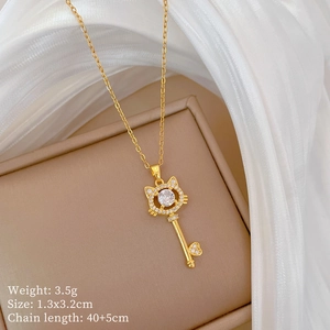 Macro shot of gold cat-head key pendant necklace with zircon inlay on jewelry box