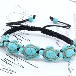 Adjustable woven bracelet with blue turquoise turtles on a white background