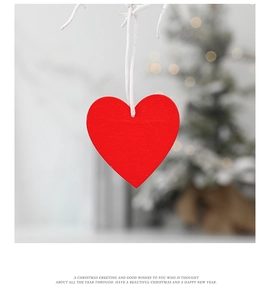 Macro shot of a red wooden heart-shaped ornament with a white hanging string