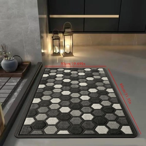 Detail showing geometric honeycomb pattern bath mat in grey shades with 50x80cm dimensions