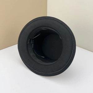 Black wool blend top hat showing internal label with material and quality details