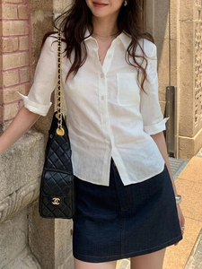 Chemisier minimaliste en lin blanc à taille ajustée avec jupe en jean bleu foncé