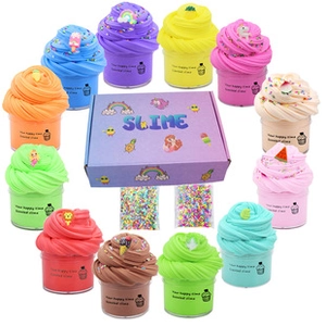 Top view of 12 multi-colored scented slime jars with DIY sprinkles and unicorn gift box