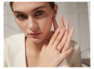 Close-up of double-layer gold stainless steel ring with micro-inlaid diamonds on hand