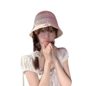 Women's breathable hollow crochet bucket hat in beige shown on model with white blouse