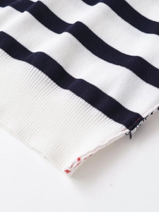 Close-up of contrast stripe knit top showing ribbed hem and fine fabric texture