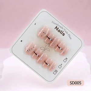 Handmade gradient pink press-on nails with silver glitter and rhinestones on display card