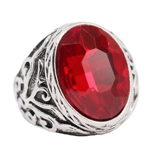 Vintage silver-tone ring with a large oval red crystal gemstone and engraved patterns