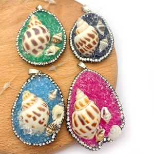 Natural conch pendants with colorful resin and crystal accents in four vibrant colors