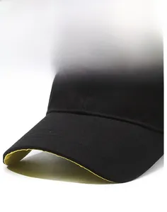 Close-up of black cotton baseball cap with yellow brim piping and detailed stitching
