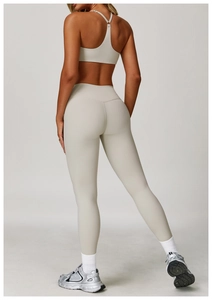 Detail of cross-back yoga bra and high-waisted leggings in oatmeal brushed fabric