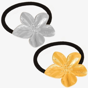 Detailed view of black elastic hair ties with polished gold and silver metal floral charms