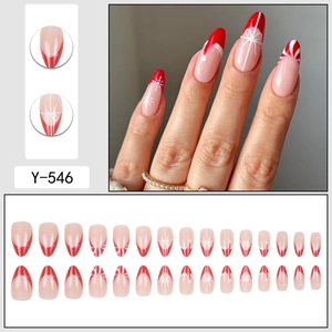 Christmas red and white almond press-on nails with snowflake and bow patterns