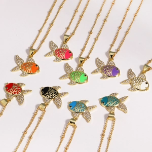 Detail of colorful enamel fish pendants with sparkling zircons on gold beaded chains