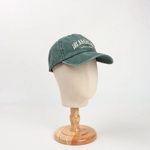 Detail of embroidered Los Angeles logo on vintage washed cotton dark green baseball cap