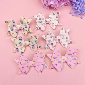 Detailed set of six glitter bow hair clips featuring floral, animal, and rainbow patterns
