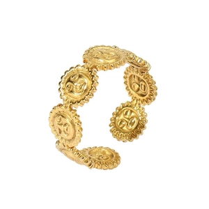 Macro detail of 18k gold plated adjustable ring featuring religious Om symbol embossed discs