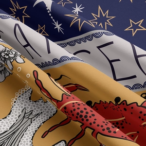 Close-up of tapestry fabric showing printed crab motif and stars on woven texture