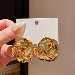 Chic gold twisted knot hoop earrings featuring a triple-spiral interlaced design