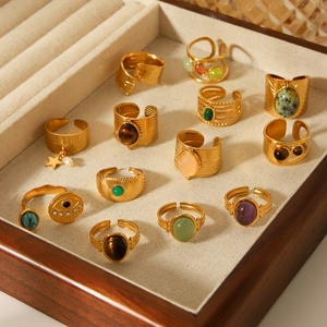Retro gold rings with natural stones and turquoise displayed in a walnut jewelry box