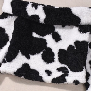 Close-up of soft black and white cow print plush fabric on this slim backless top
