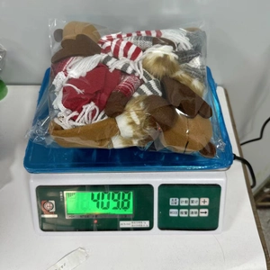 Detailed view of plush Christmas reindeer dolls being weighed for quality assurance