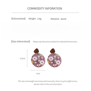 Detail view of round wooden floral earrings with 5.5cm length and silver needle specifications