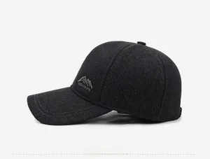 Detail of grey wool baseball cap showing peak logo embroidery and double-stitched brim