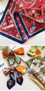 Detail of elegant silk scarves featuring artistic mythical prints on satin texture