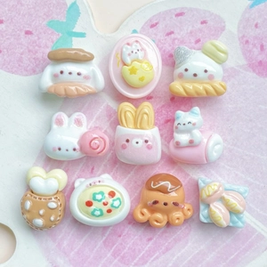 Miniature resin cartoon animal charms for DIY crafts and hair clips on pink background